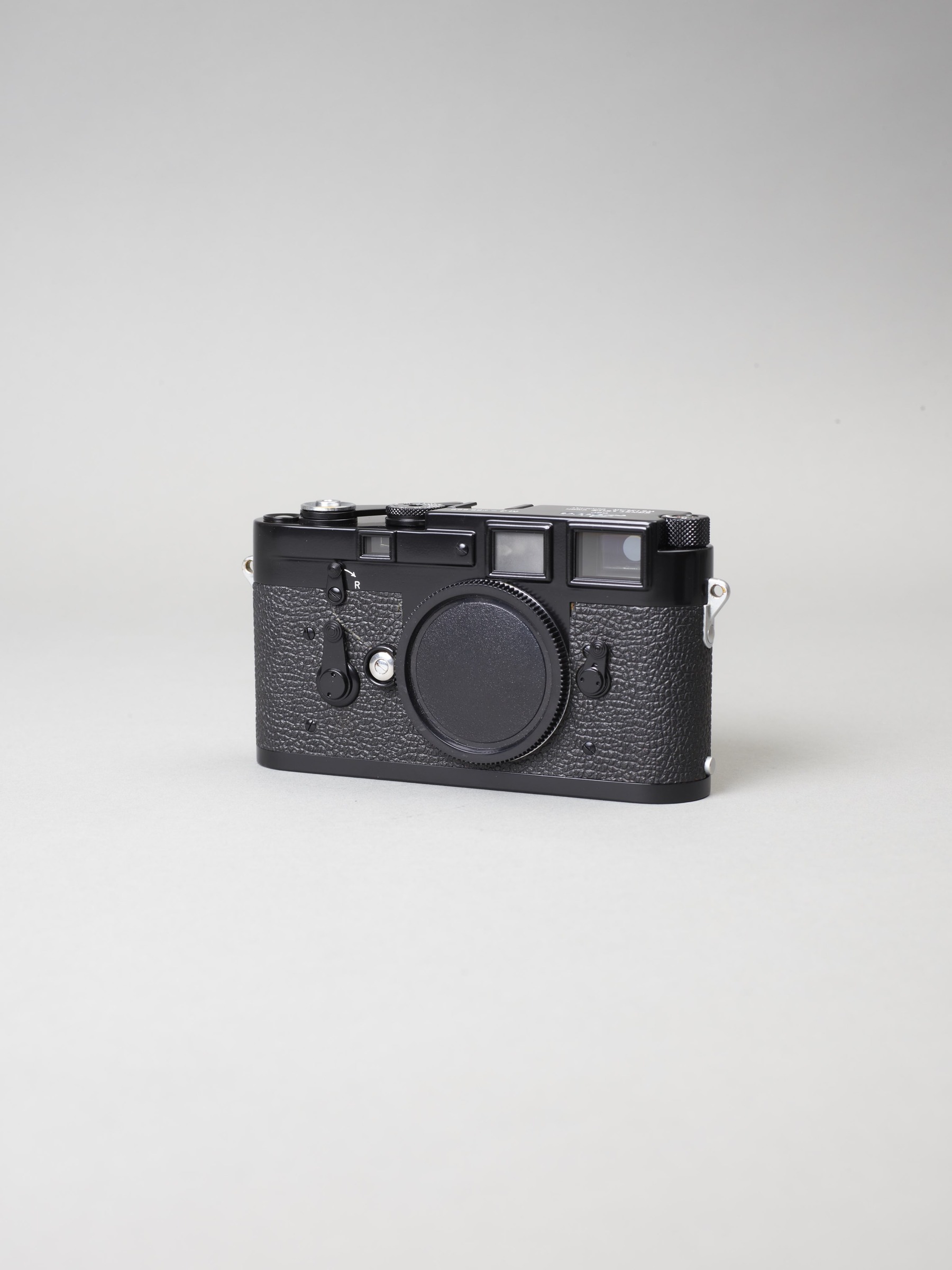Leica M3 in a black finish, photographed on a grey background
